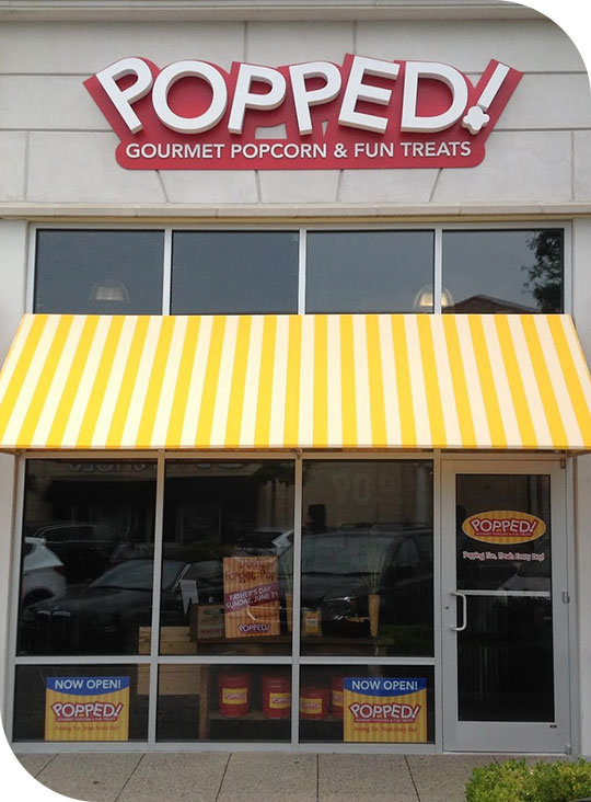 custom awning outside Popped! Gourmet Popcorn & Fun Treats